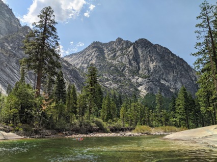 Cooling down in the Tuolumne River with a view of Colby Mountain, in Yosemite National Park